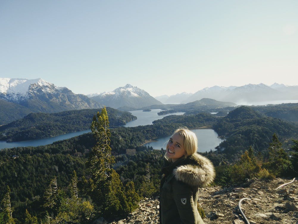 Kim looking happy standing over a valley in Bariloche